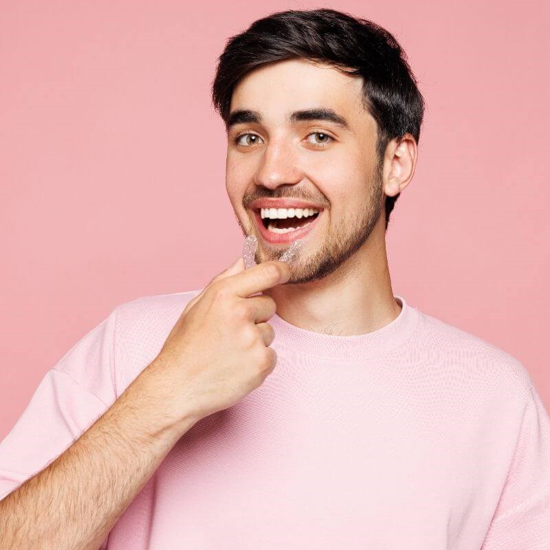 Man smiling with clear aligners